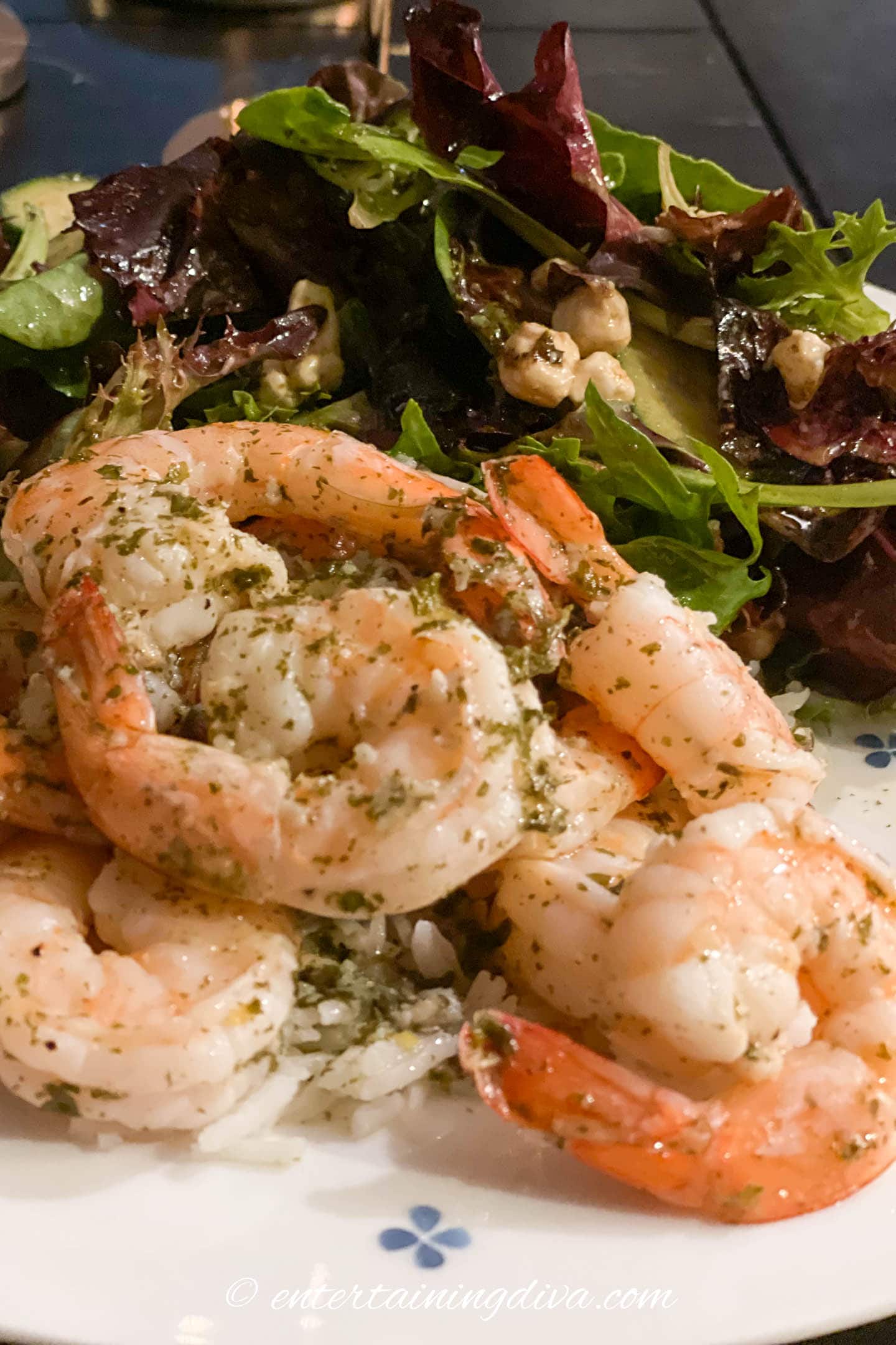 lemon garlic shrimp on a plate with rice and salad