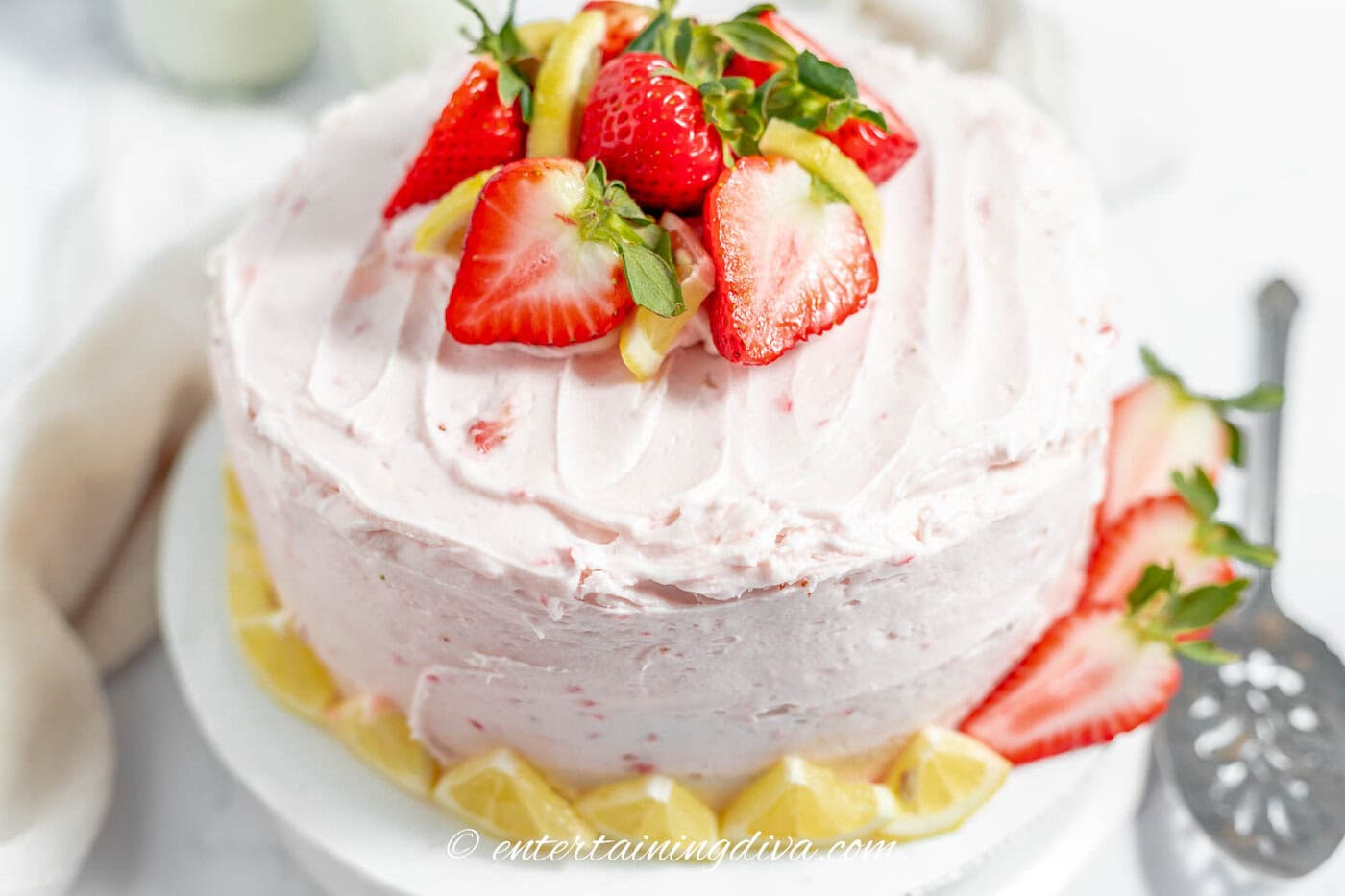 Overhead view of lemon cake with strawberry frosting