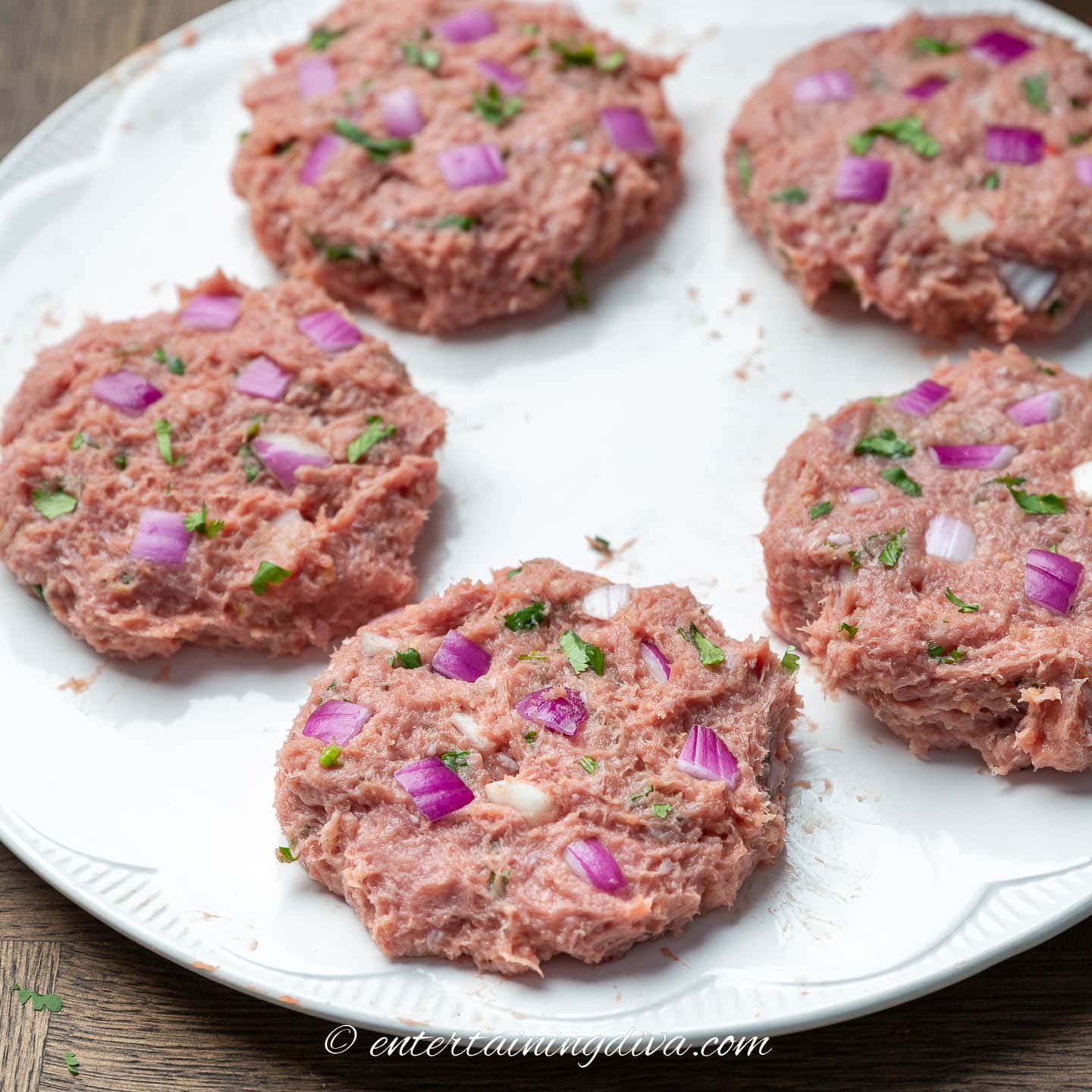 raw lemon cilantro turkey burger patties on a plate