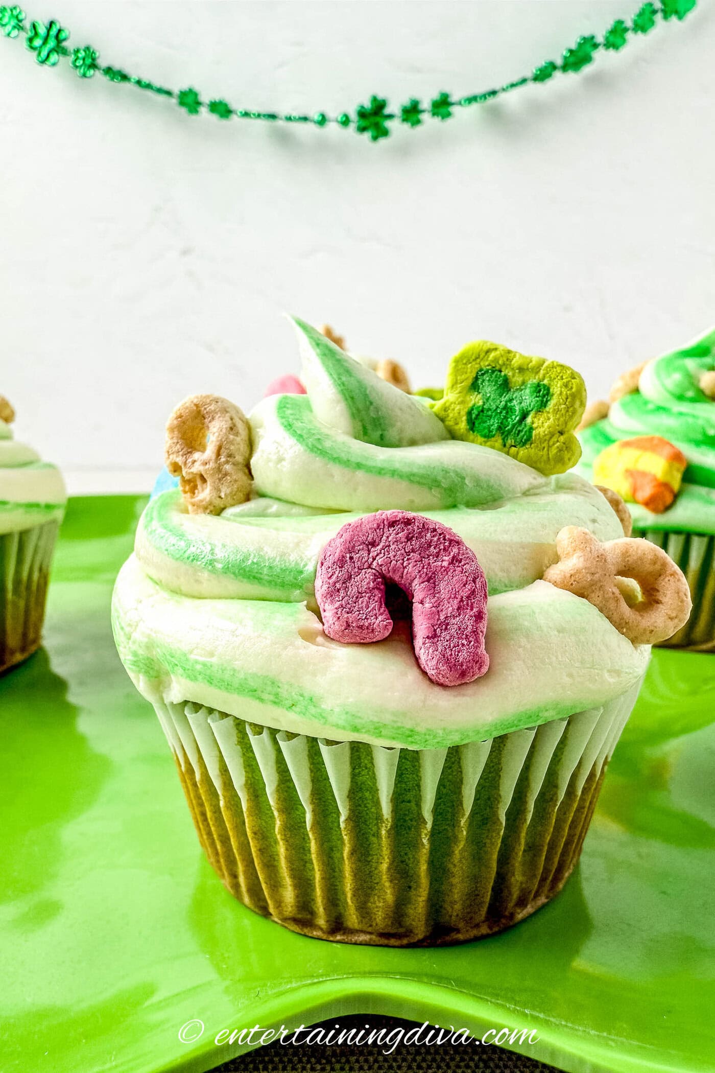A lucky charms cupcake on a plate