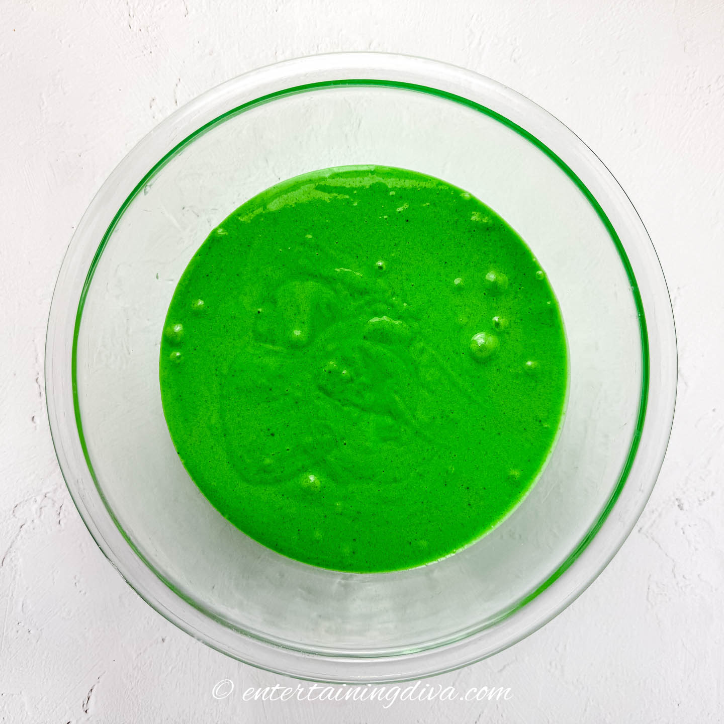green cake mix batter in a mixing bowl