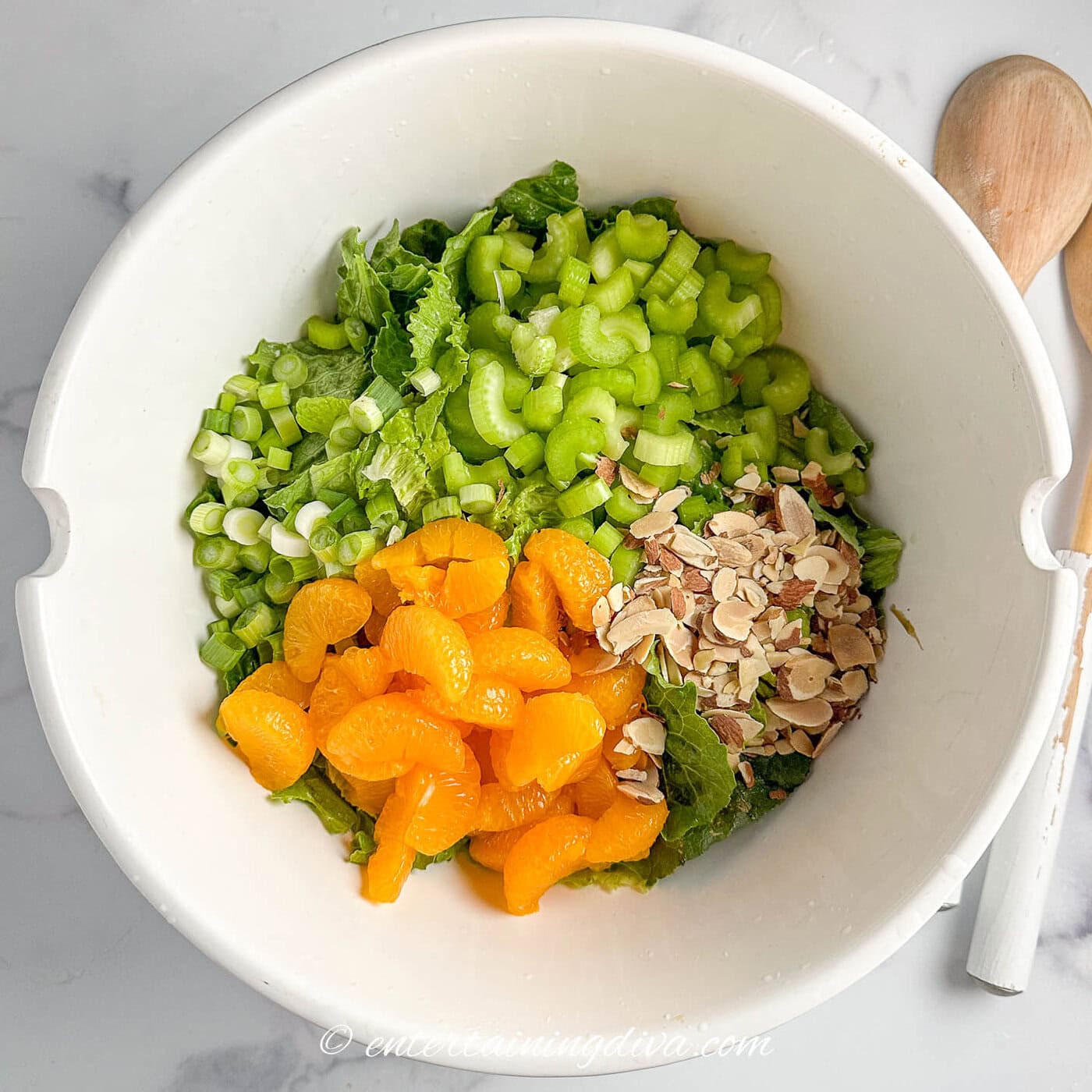mandarin orange romaine salad in a bowl before mixing.