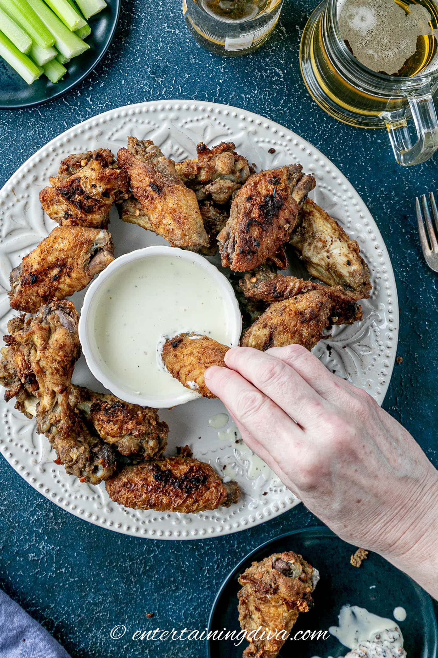 Marinated Asian spiced wings on a plate with blue cheese dressing