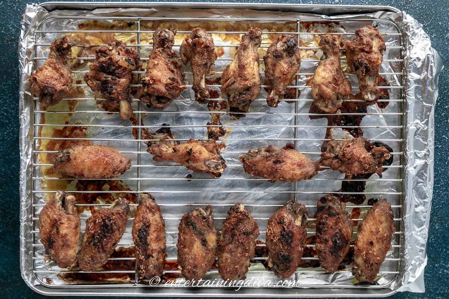 baked marinated spiced chicken wings on a baking sheet after they have been cooked