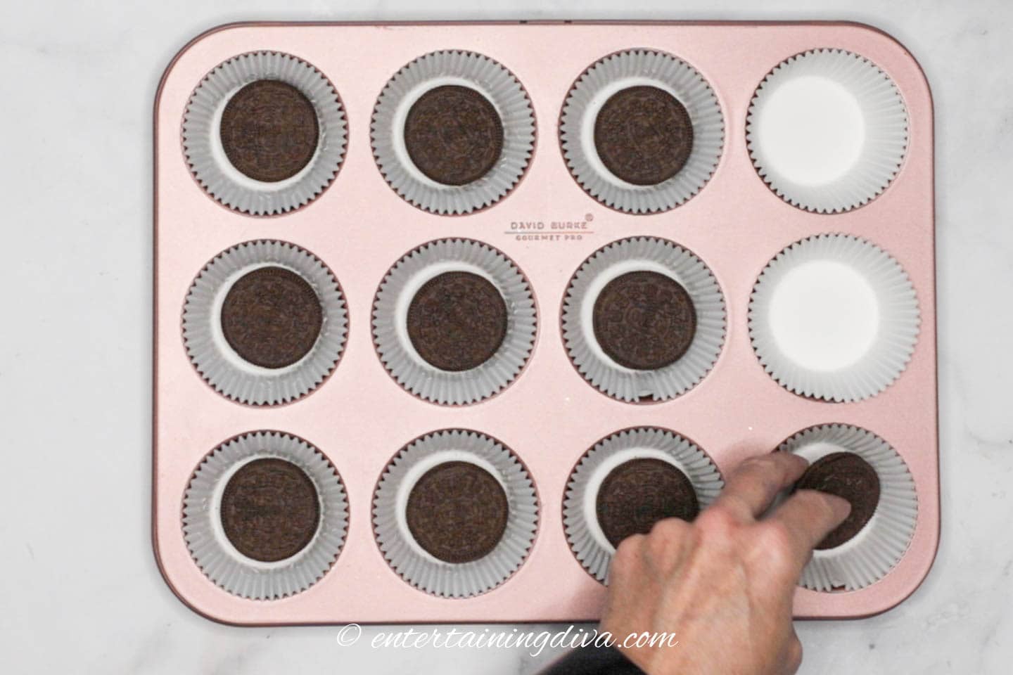 Oreo cookies in the bottom of cupcake liners