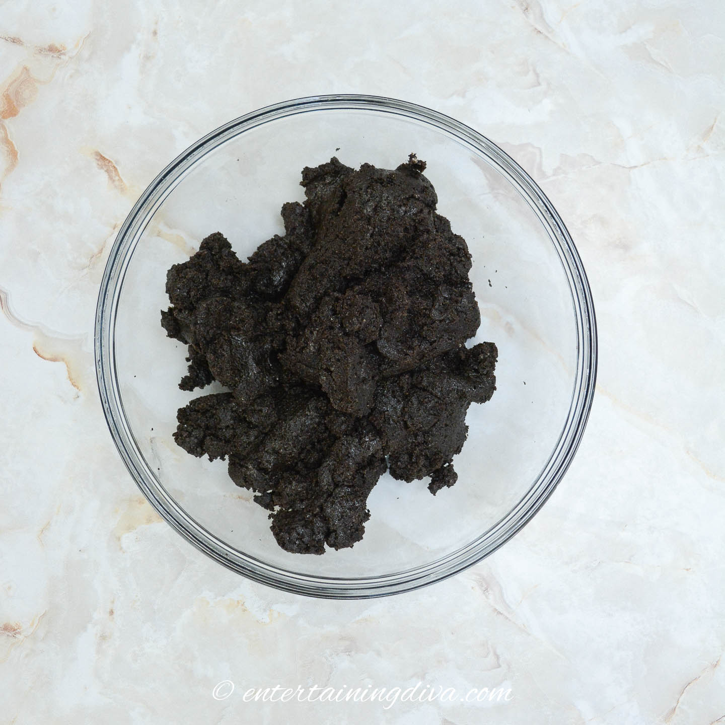Oreo cookies mixed with cream cheese in a bowl