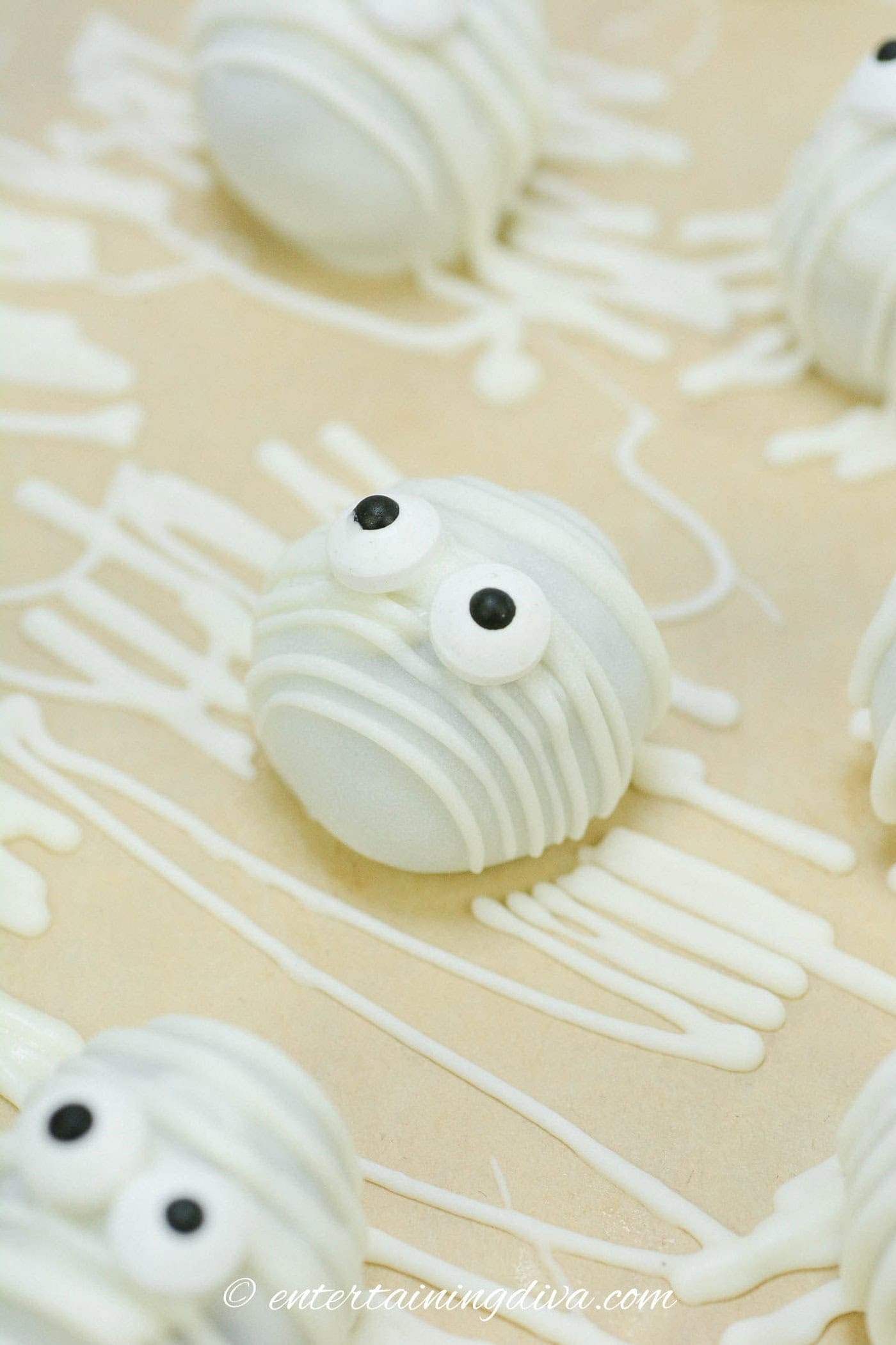 close up of a mummy Oreo after it has been decorated with white chocolate