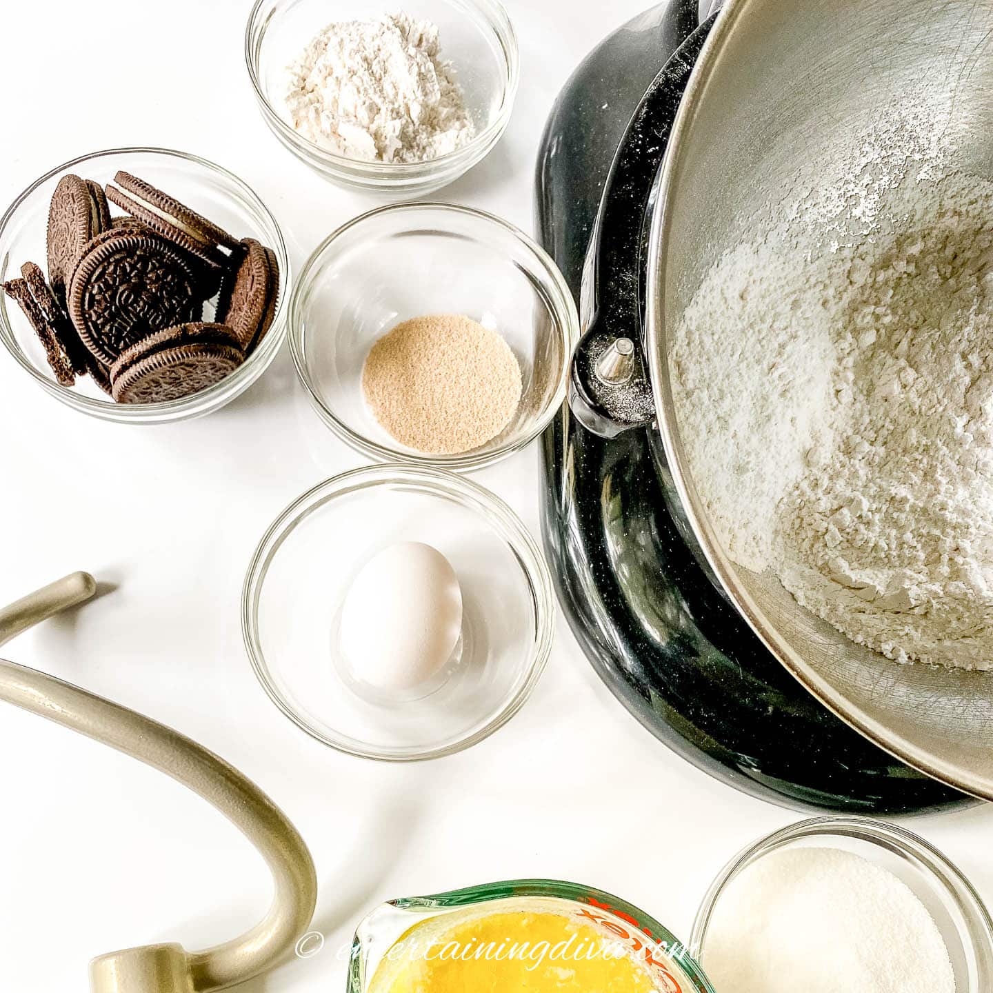 Cinnamon roll dry ingredients in a bowl surrounded by other ingredients