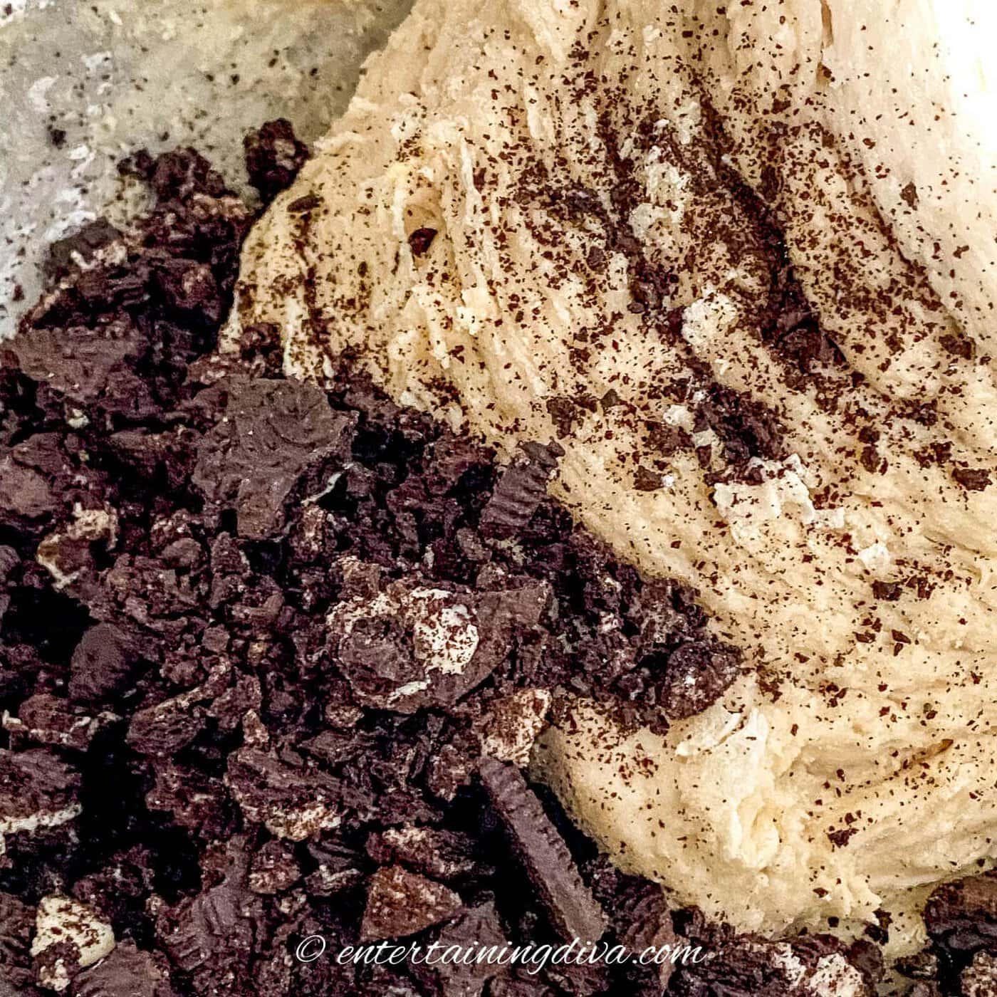 crushed Oreo cookies in a mixing bowl with cinnamon roll dough