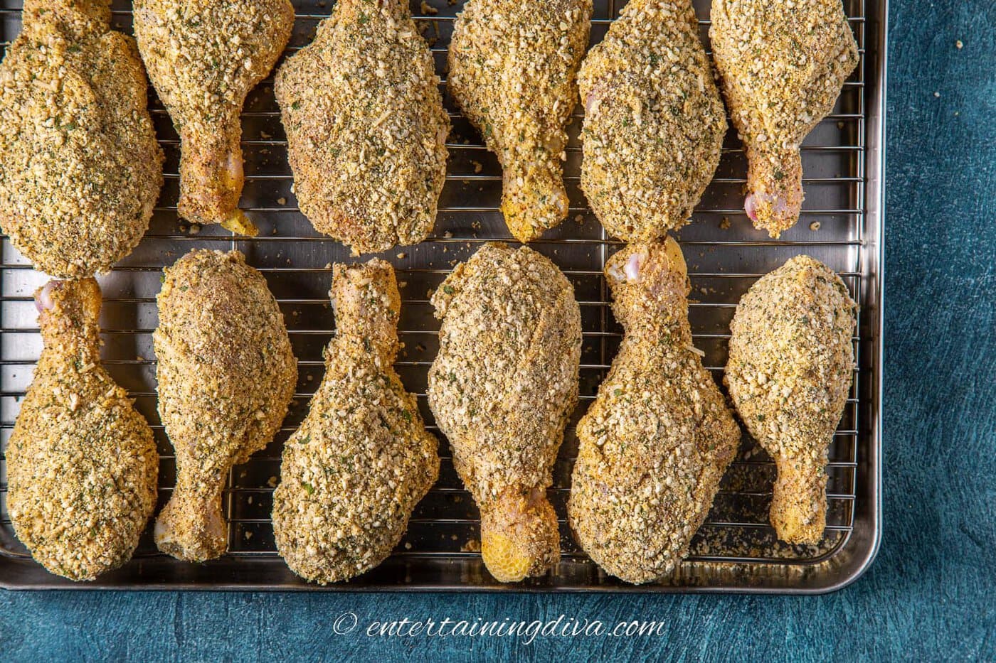 oven baked breaded drumsticks on a baking sheet before baking