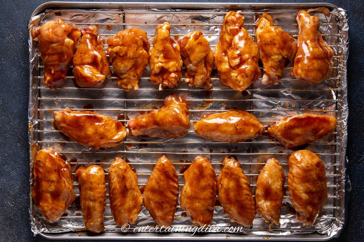 Chicken wings with oyster sauce on a baking sheet before cooking