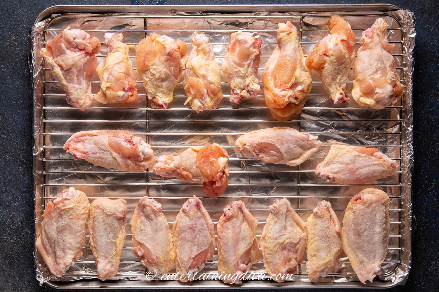 wings laid out in a single layer on a wire rack on a baking sheet