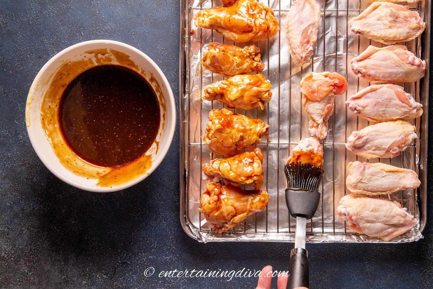 oyster sauce being brushed onto the wings