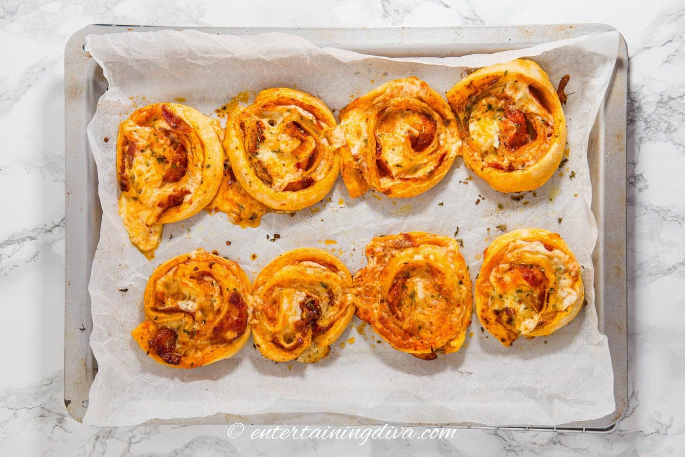 pepperoni pinwheels on a baking tray after being baked