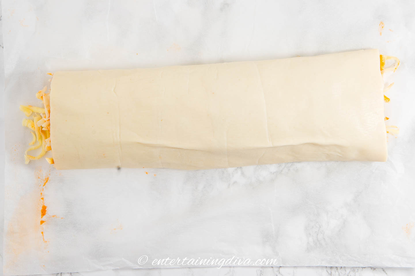 A pepperoni pizza rollup log before it is cut