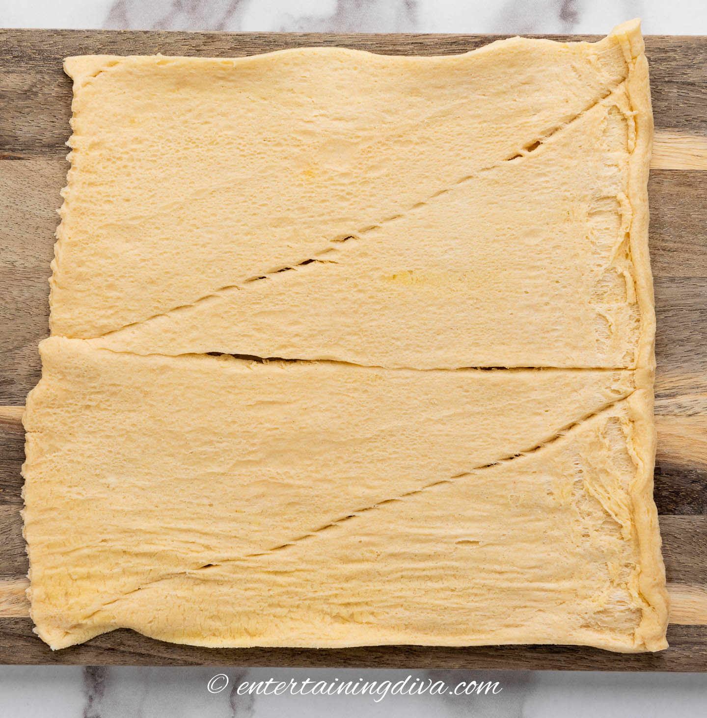 crescent roll dough laid out on a cutting board