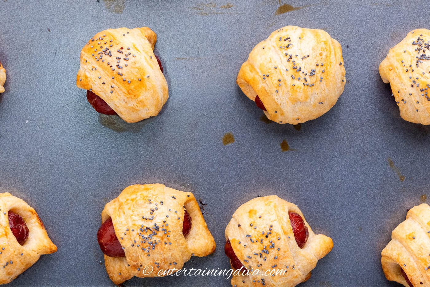pigs in a blanket on a baking sheet after baking
