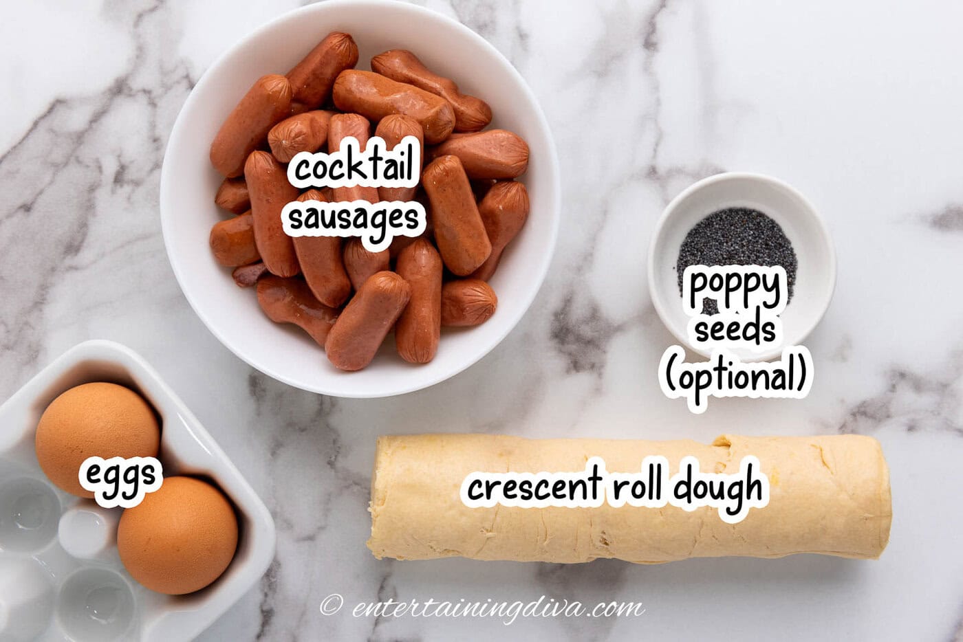 pigs in a blanket ingredients - crescent roll dough, cocktail sausages, eggs, poppy seeds for garnish