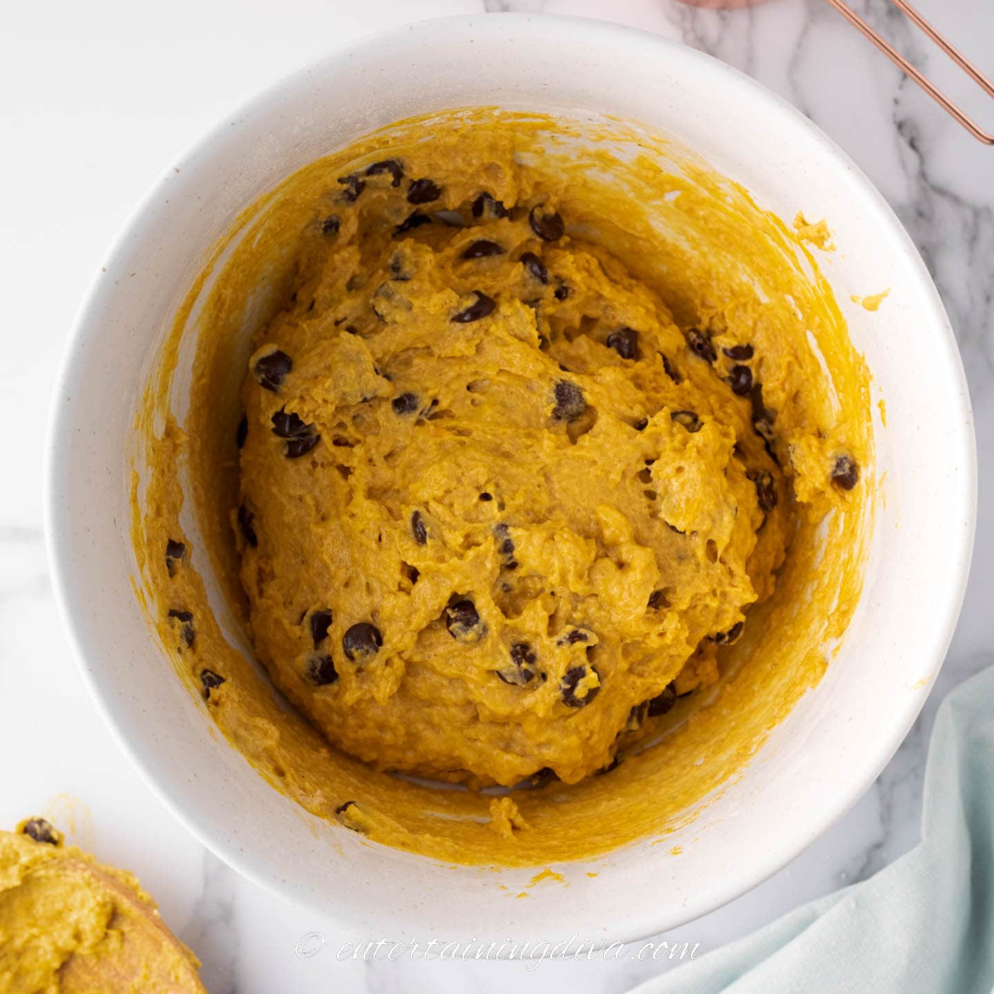 pumpkin chocolate chip muffin batter in a bowl