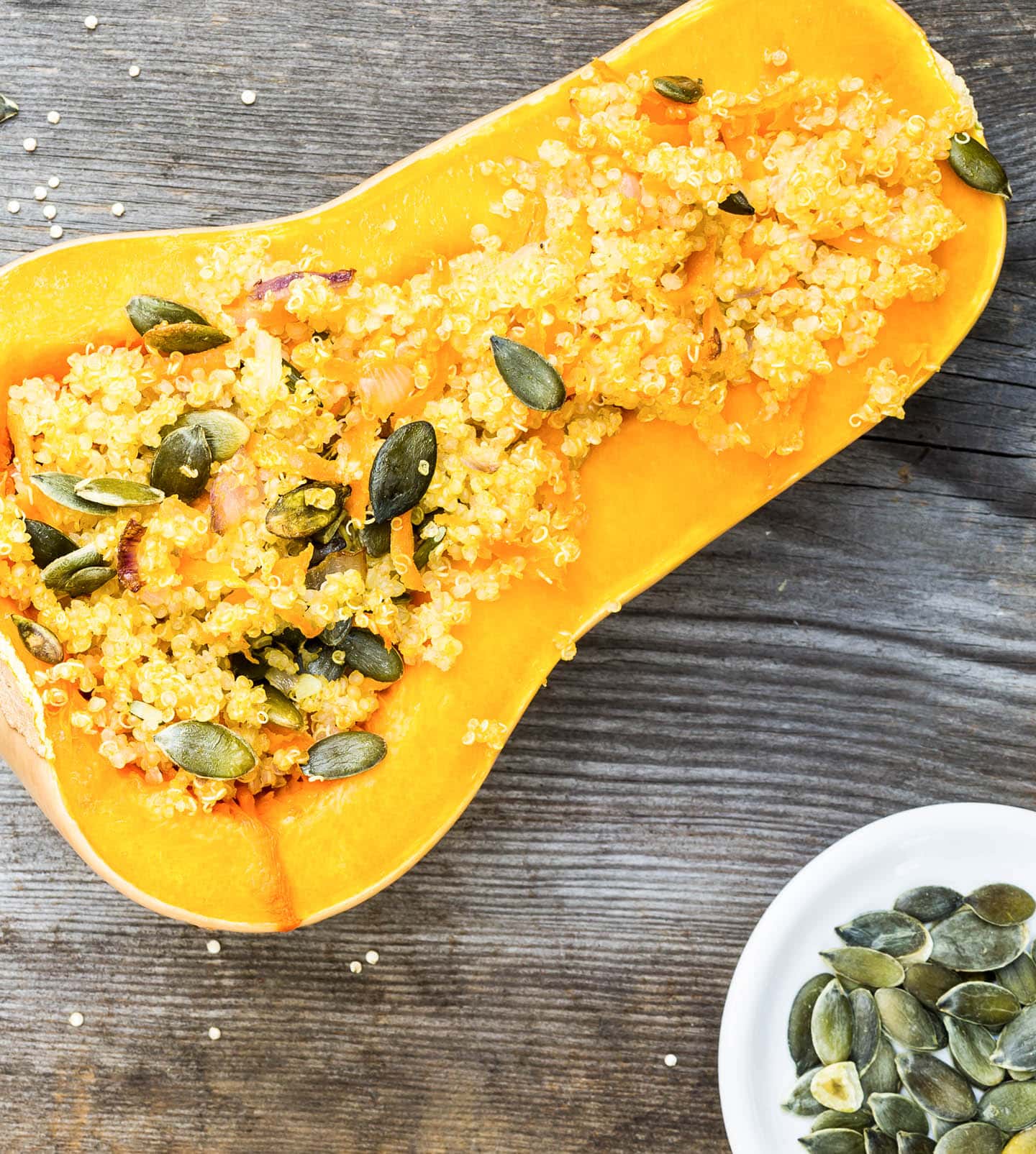 quinoa and pumpkin seeds in half a butternut squash