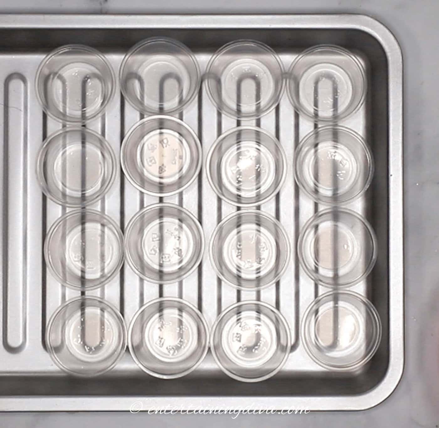 empty jello shot cups on a baking tray