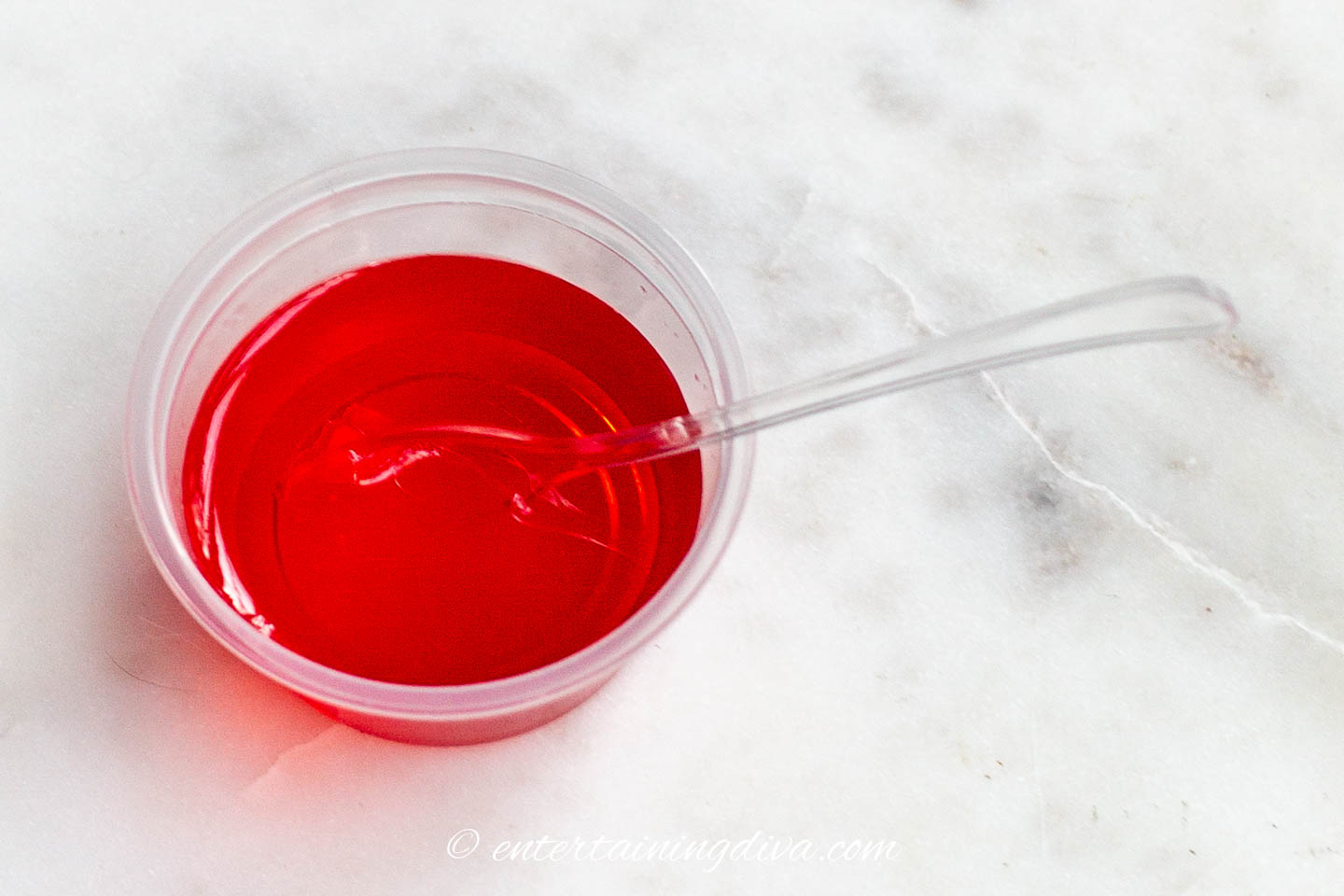 a raspberry lemonade jello shot with a tasting spoon