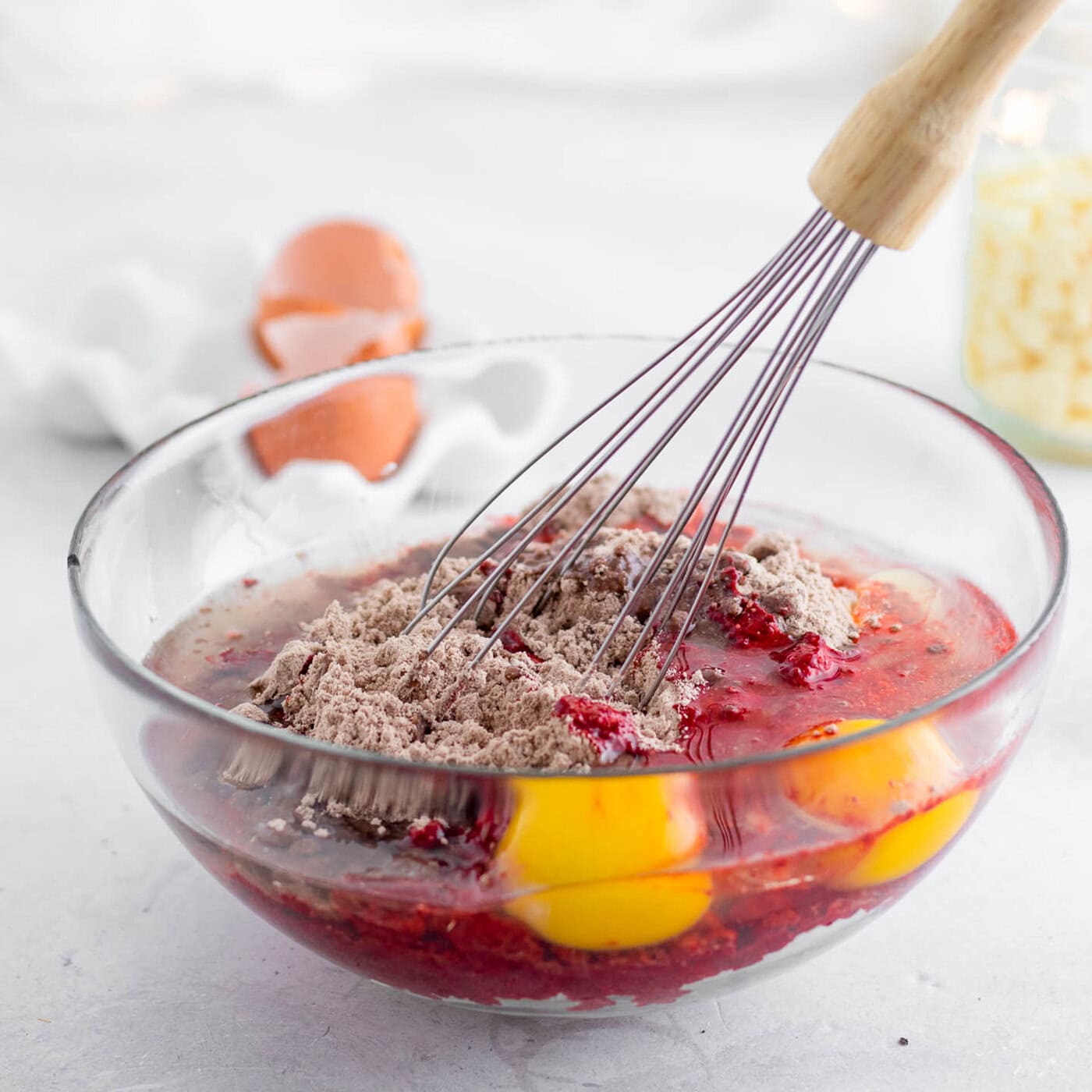 red velvet cake mix, eggs and oil being mixed in a bowl