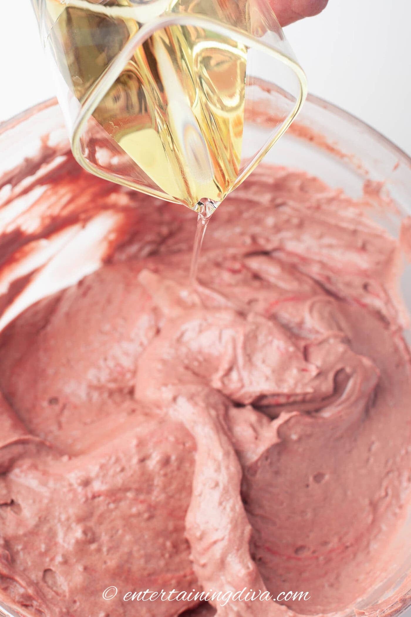 oil being added to the red velvet cupcakes batter