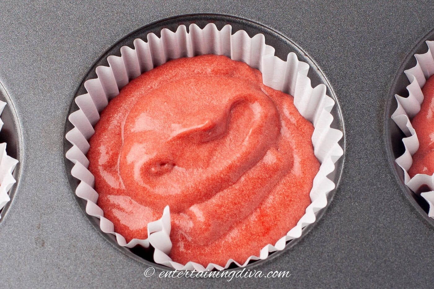 red velvet cupcake batter in a cupcake liner