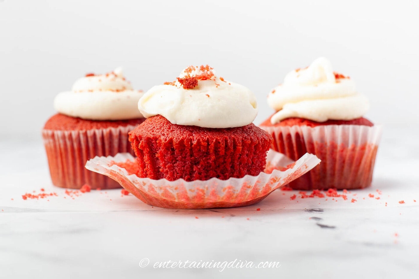 side view of red velvet cupcakes with cream cheese frosting