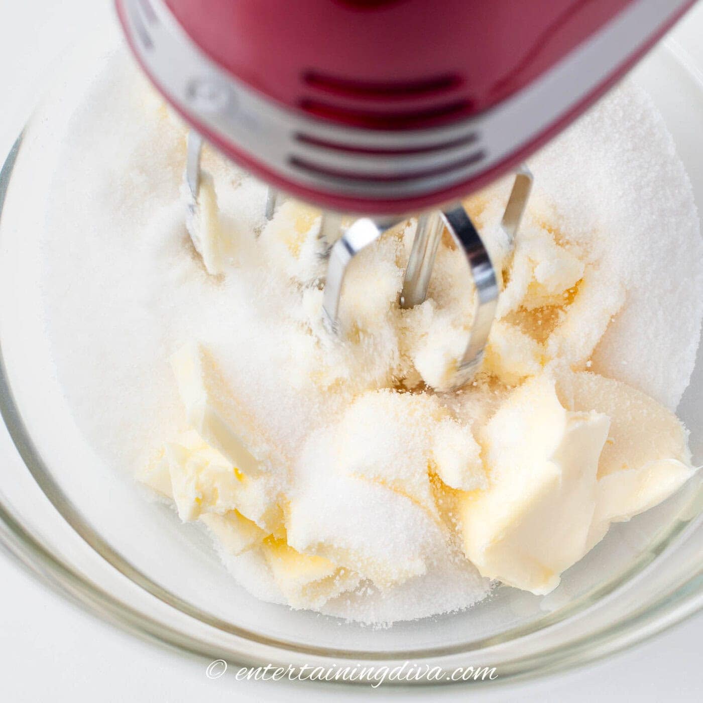 butter and sugar being mixed with a mixer