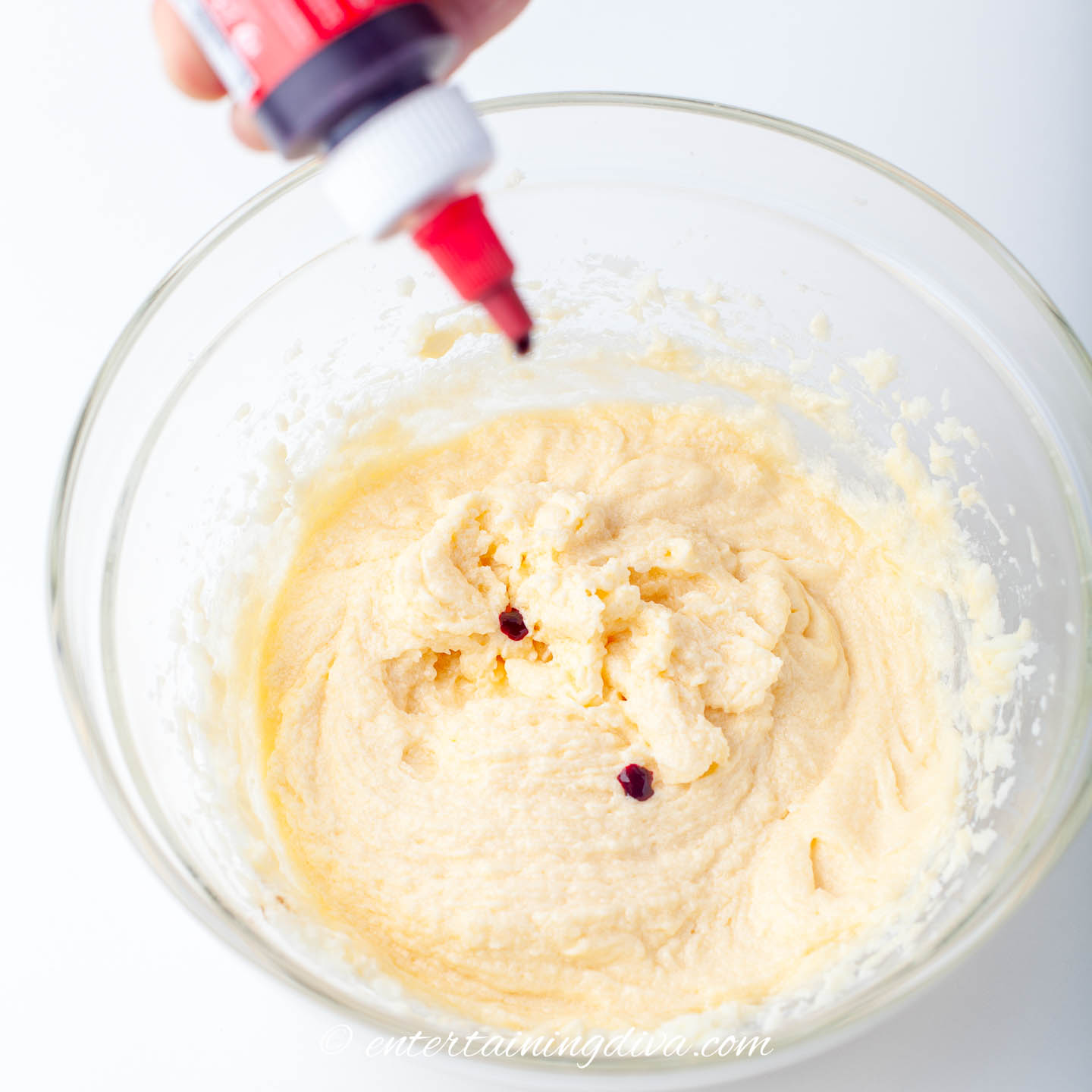 red food coloring being added to red velvet cupcakes batter