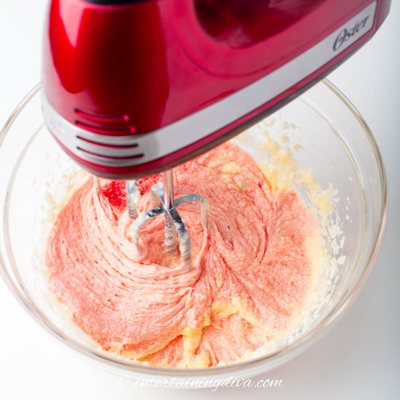 red velvet cupcakes being mixed after red food coloring has been added