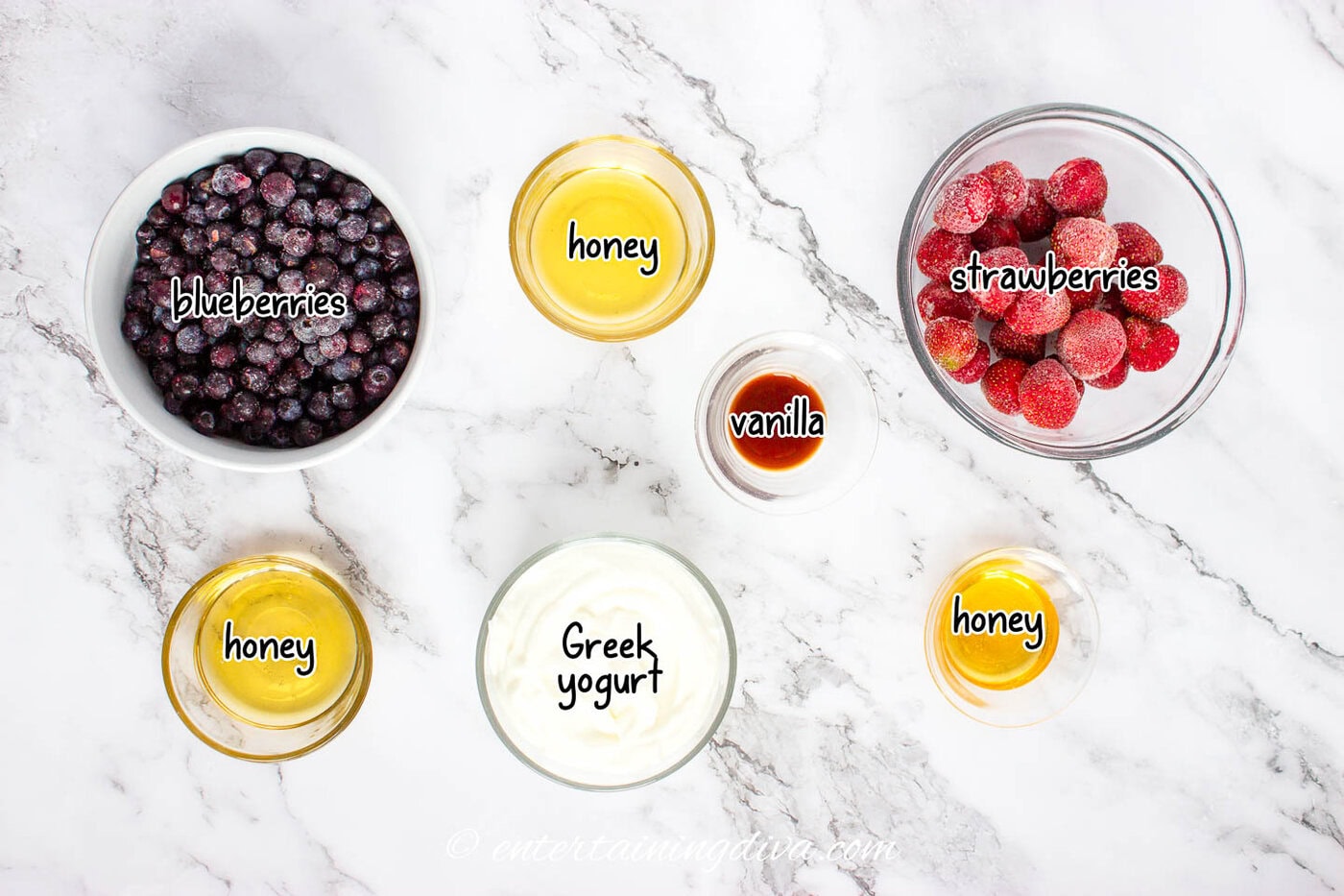 ingredients for red white and blue popsicles - blueberries, strawberries, honey, vanilla and Greek yogurt