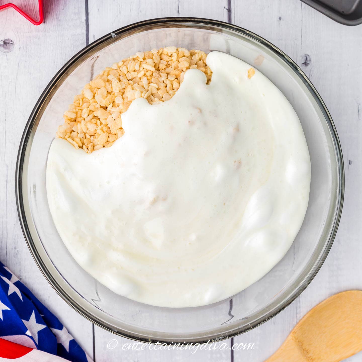 melted marshmallow mixture and rice krispies in a mixing bowl