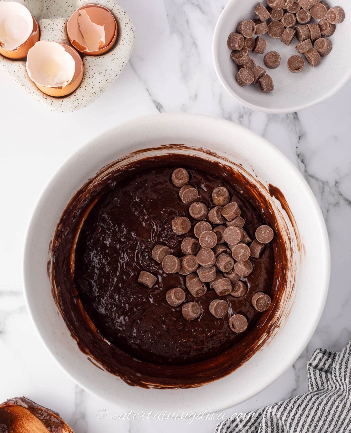 Rolos added to the melted chocolate mixture in a bowl.