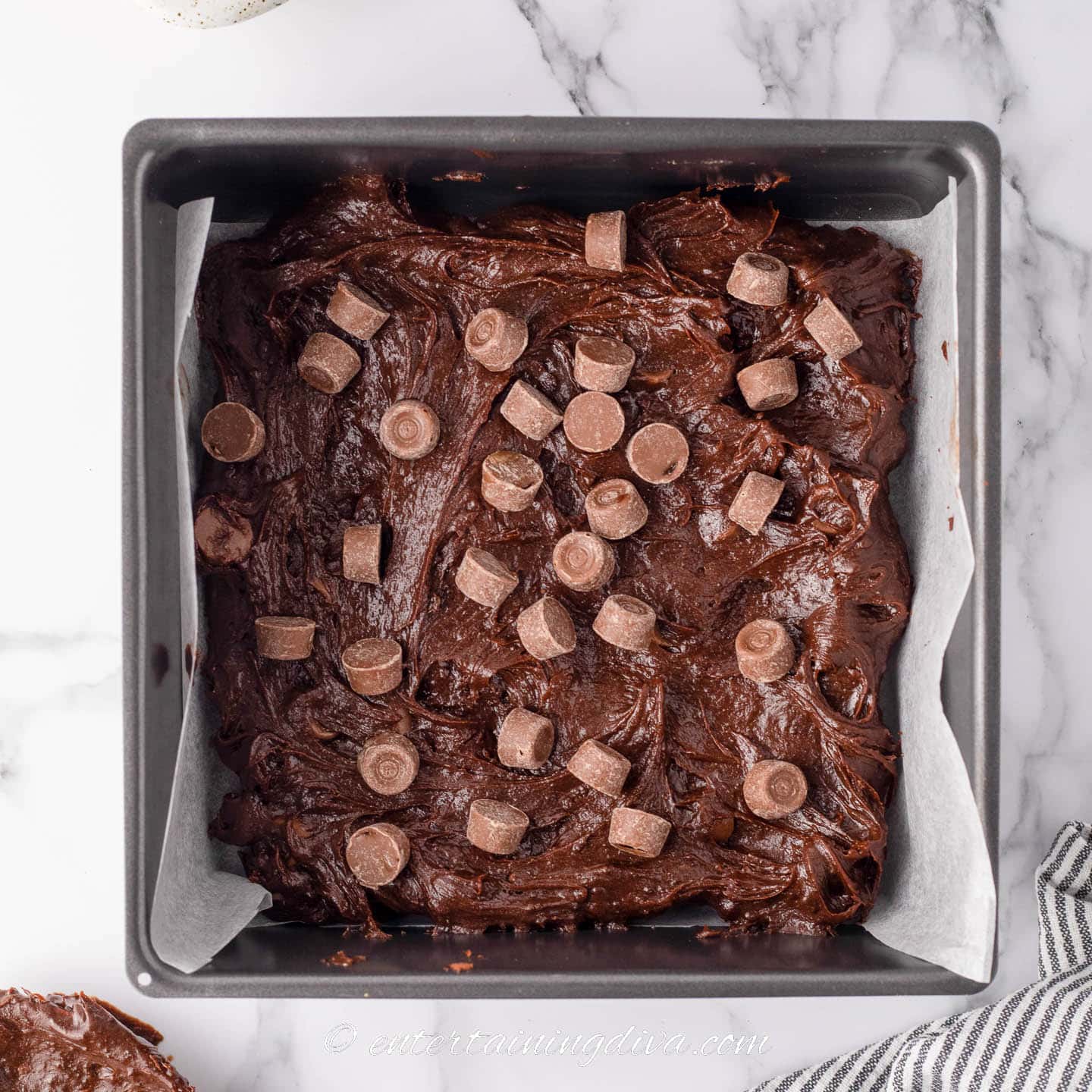 Brownie mixture a 9-inch baking pan with Rolos spread out on top