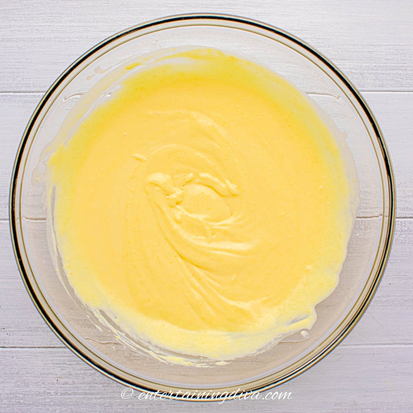 rumchata, milk and pudding mix combined in a bowl