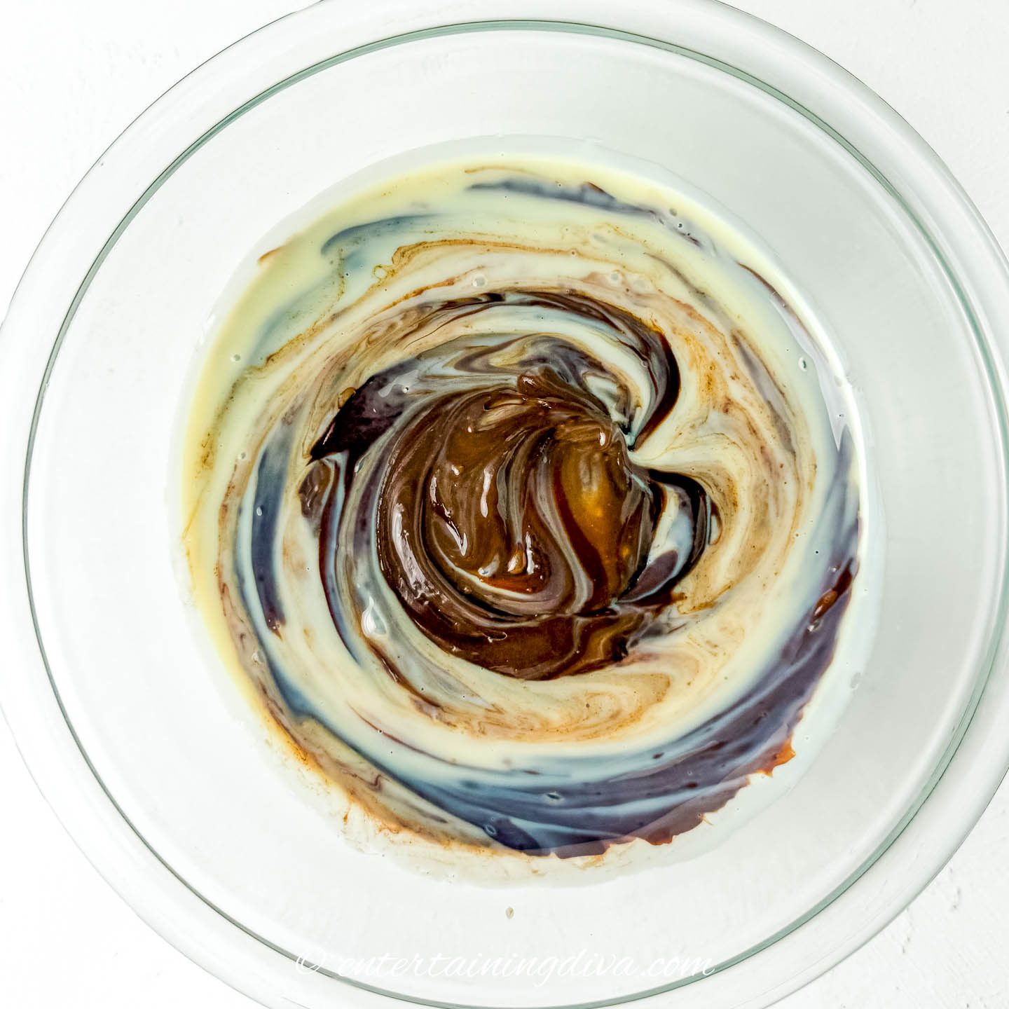 Melted chocolate being mixed with sweetened condensed milk