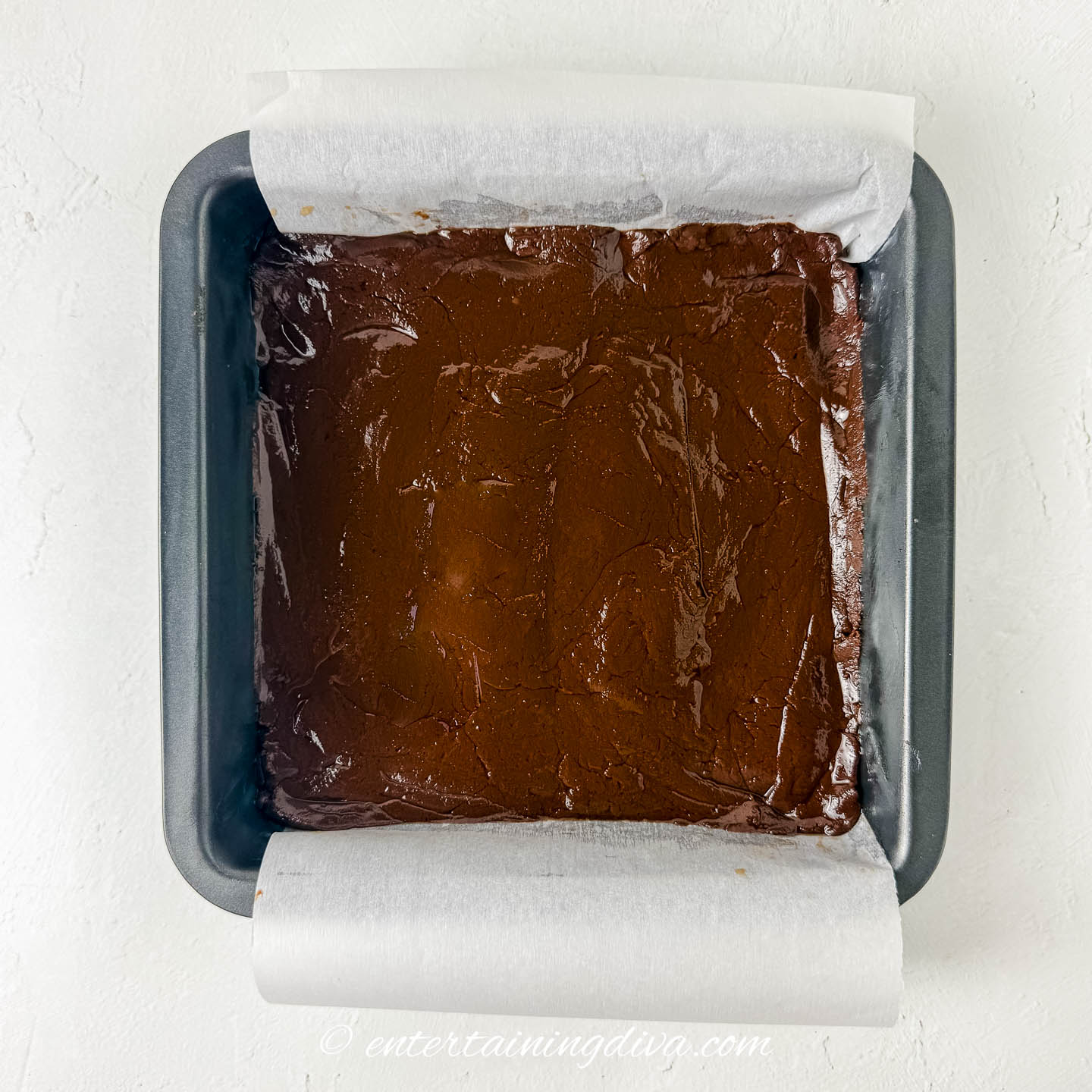 chocolate fudge in the bottom of an 8" x 8" cake pan