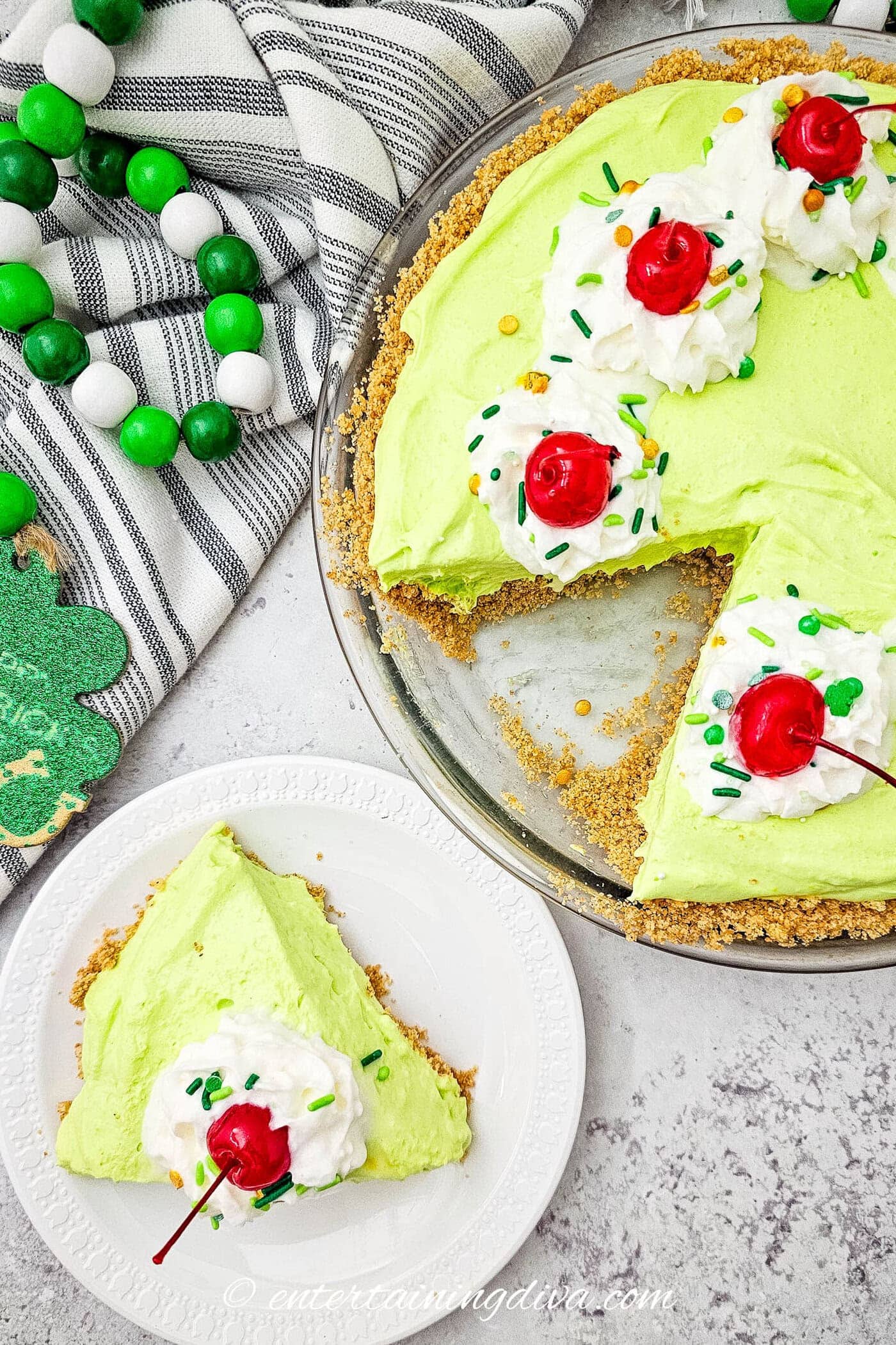 A piece of shamrock shake pie of a plate beside the rest of the pie in a pie pan