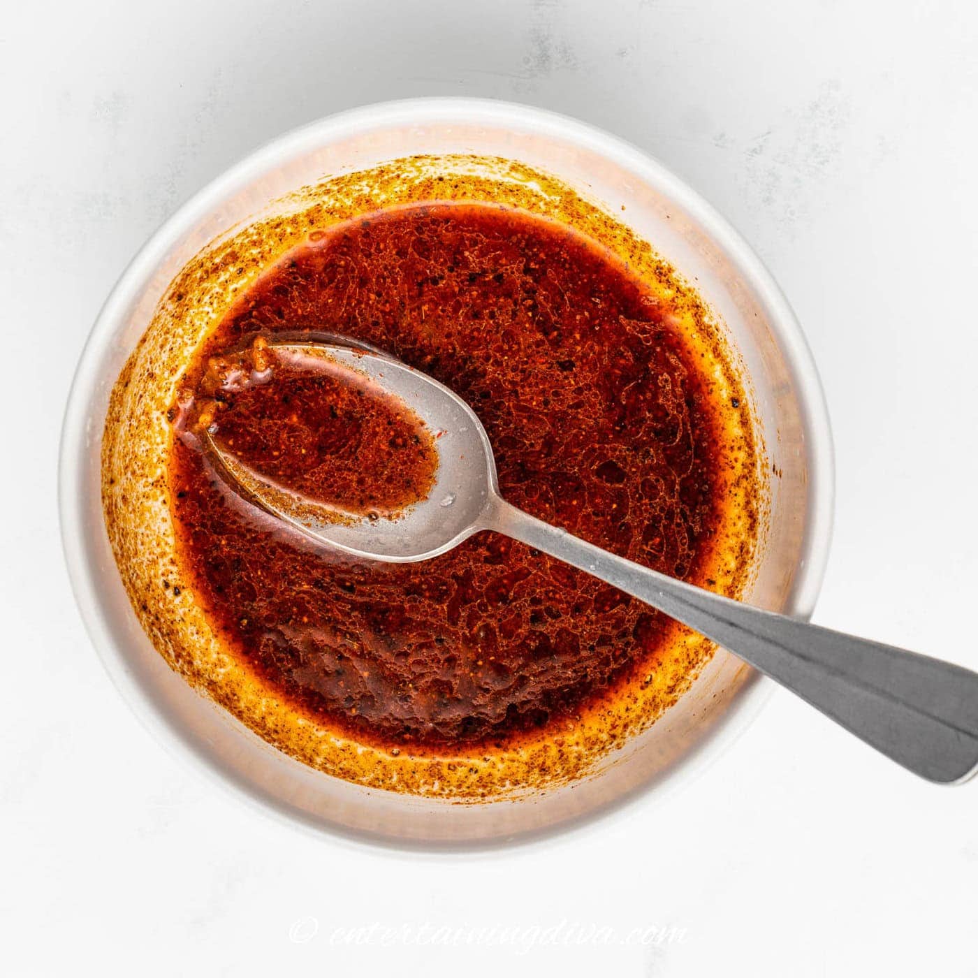 marinade for shrimp in a bowl with a spoon