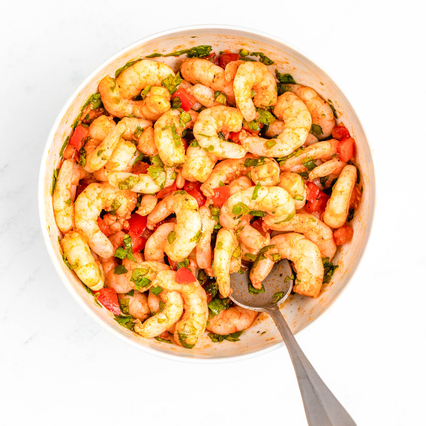 shrimp, tomatoes, and jalapeno pepper mixed in a bowl