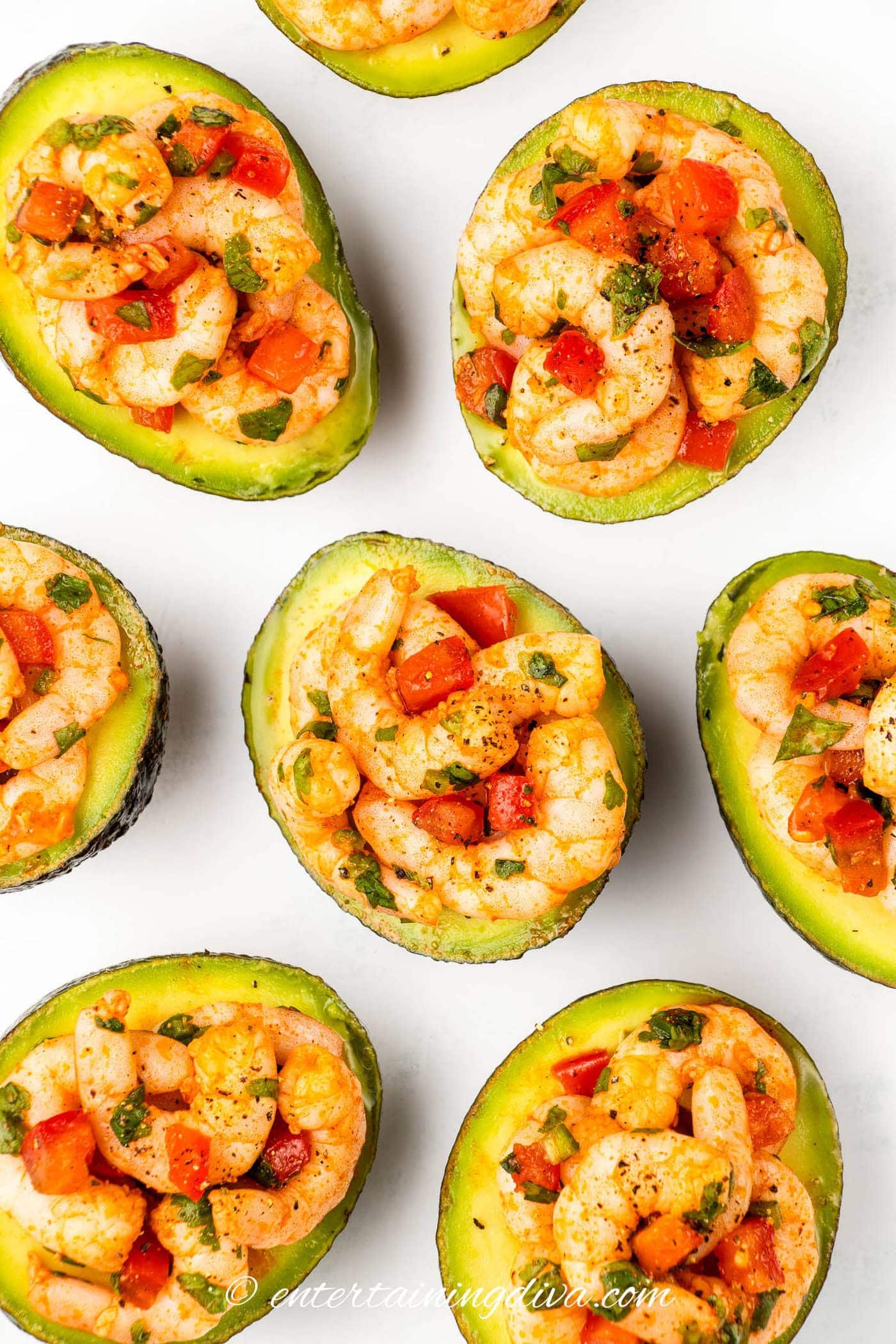 overhead picture of avocados filled with shrimp on a plate