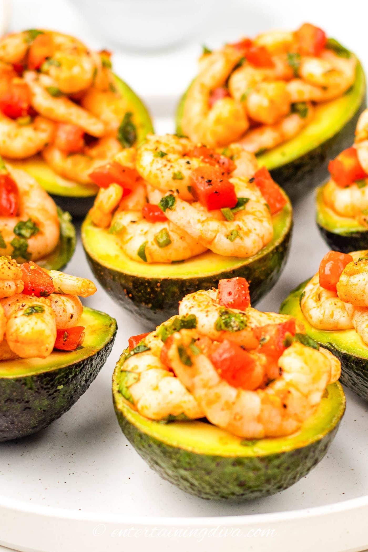 shrimp filled avocados on a plate