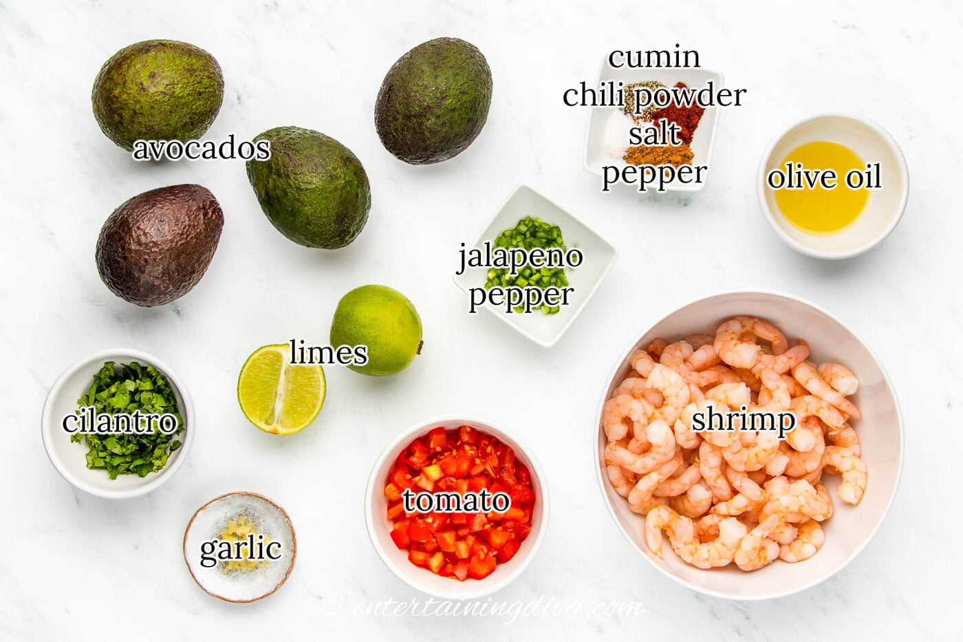 shrimp stuffed avocados ingredients - avocados, shrimp, cilantro, limes, garlic, tomato, jalapeno pepper, cumin, chili powder, salt pepper, olive oil