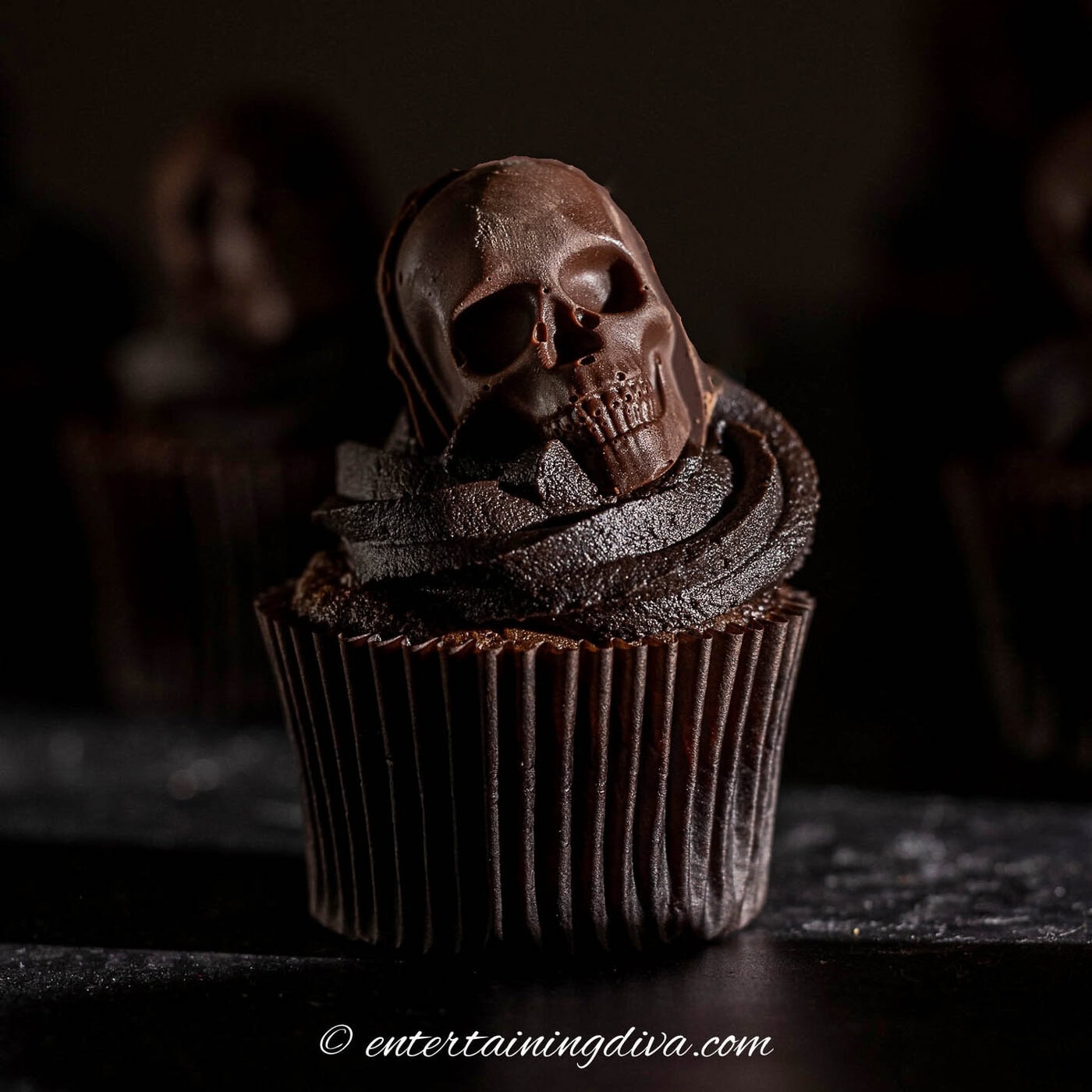 a skull cupcake on a dark background