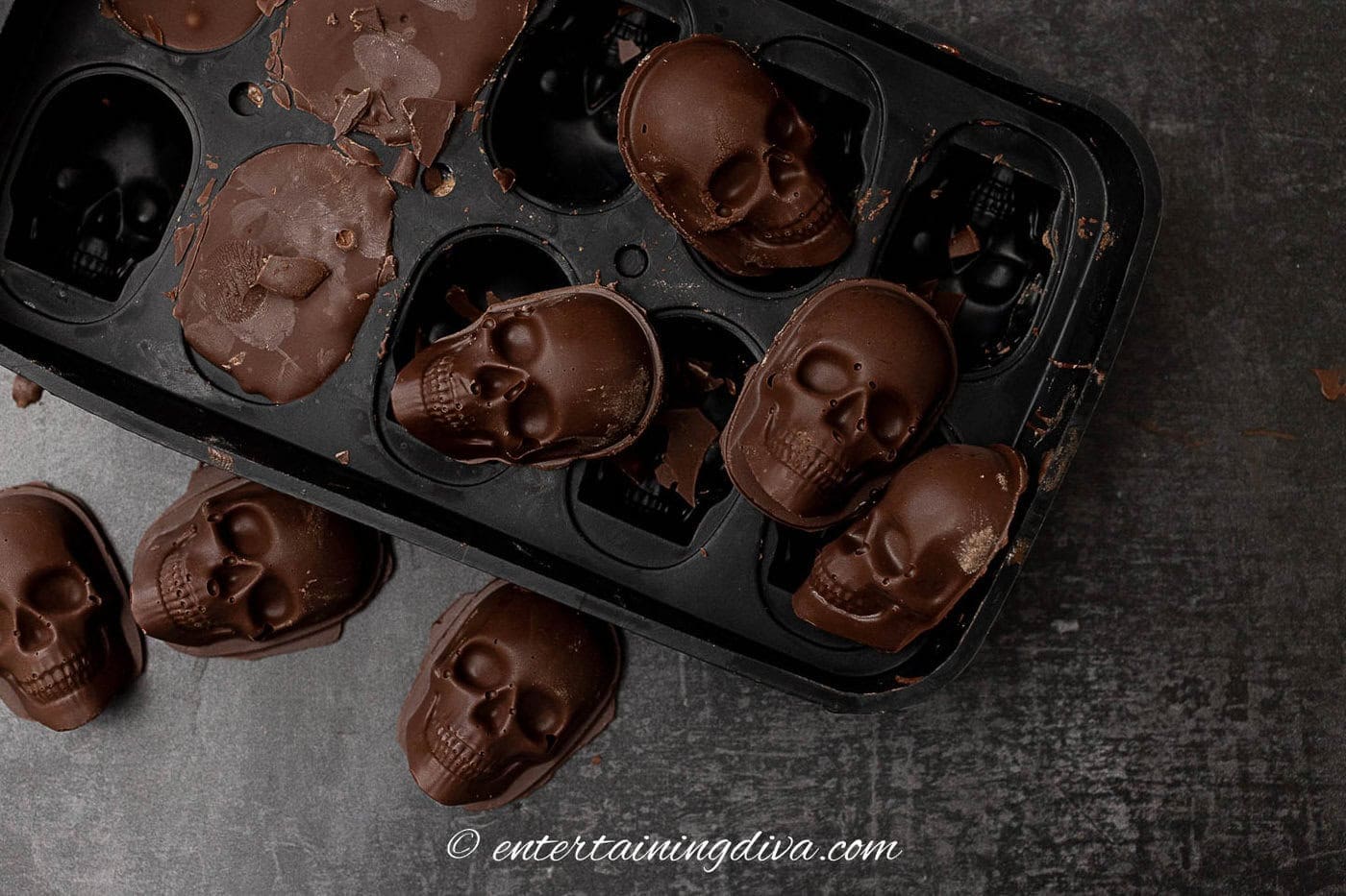 chocolate skulls being removed from a skull mold