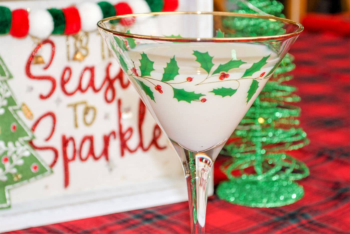 A martini glass with a christmas tree on it.