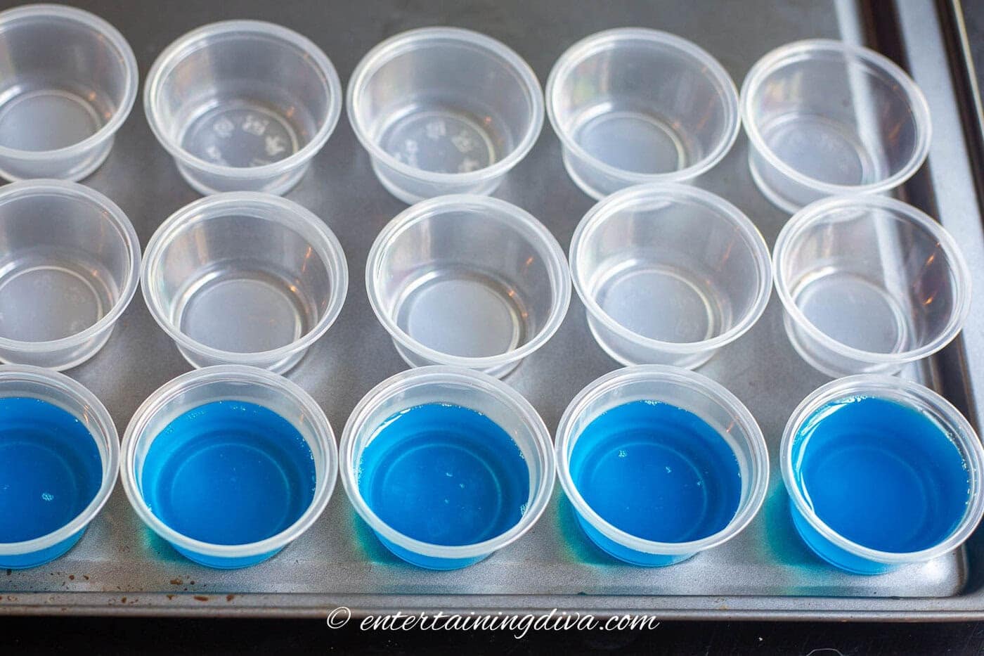 jello shot cups filled with sour apple berry blue jello shot mix